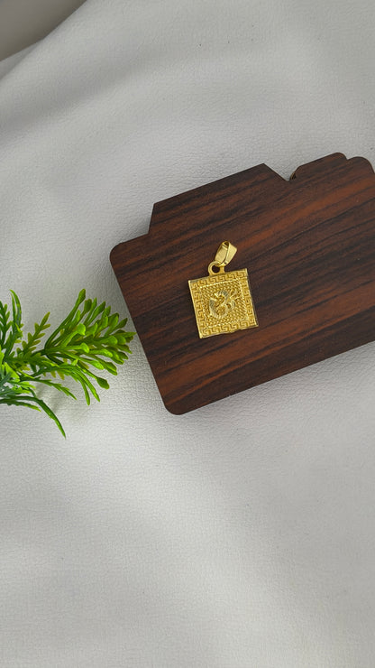 square-shaped gold-plated Om pendant.