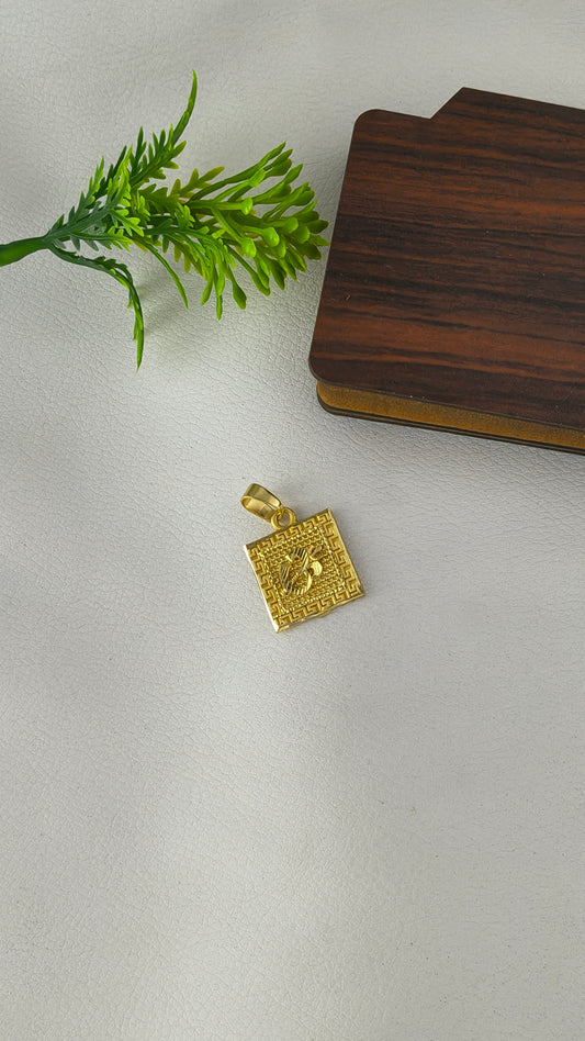 square-shaped gold-plated Om pendant.